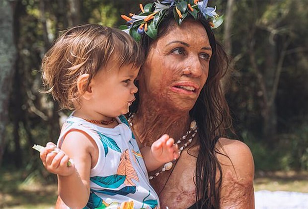 Turia Pitt holding son Hakavai on first birthday with garlands in their hair