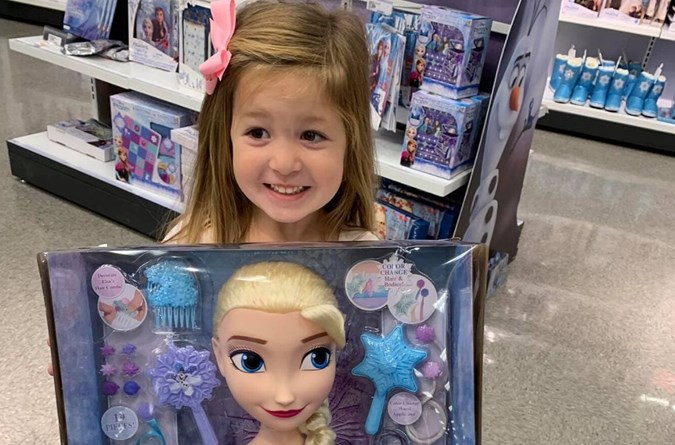 Emmerson posing with Frozen toys she wants for Christmas. Image: Facebook