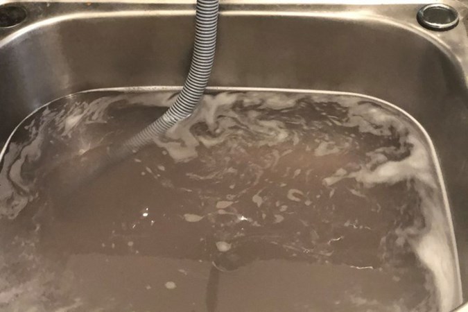 Jenny revealed the dirty water that was flushed from her washing machine after using 4 dishwashing tablets on a hot cycle. Credit: Mums Who Clean/Facebook