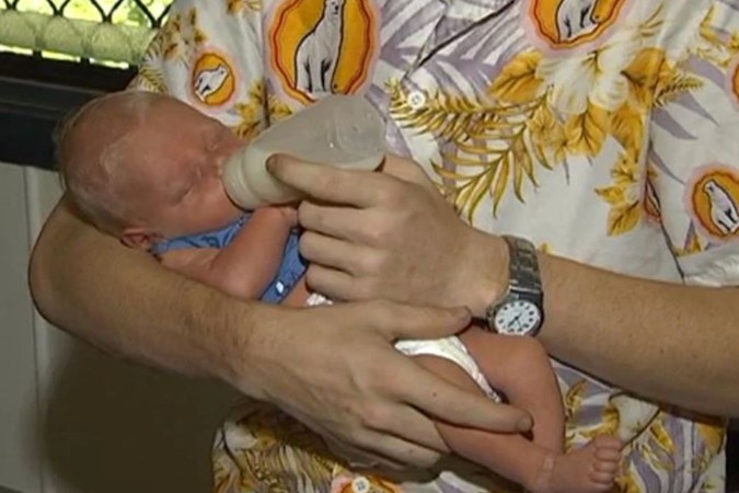 Cooper Woods in the arms of his father Blairdon. Image: 7NEWS