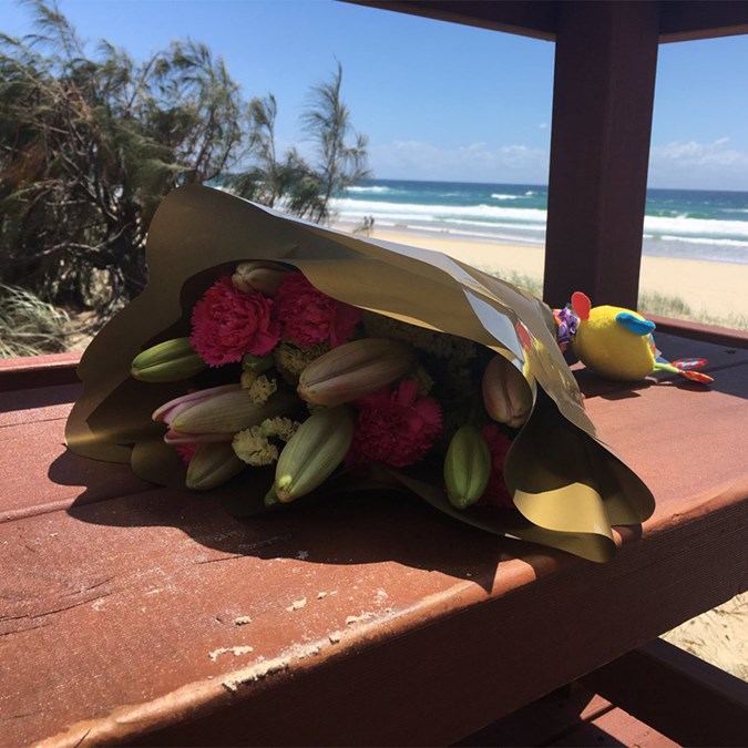 Tributes laid in memory of the little girl found dead on beach at Surfers Paradise